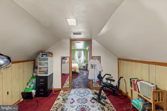 interior space with lofted ceiling and wooden walls