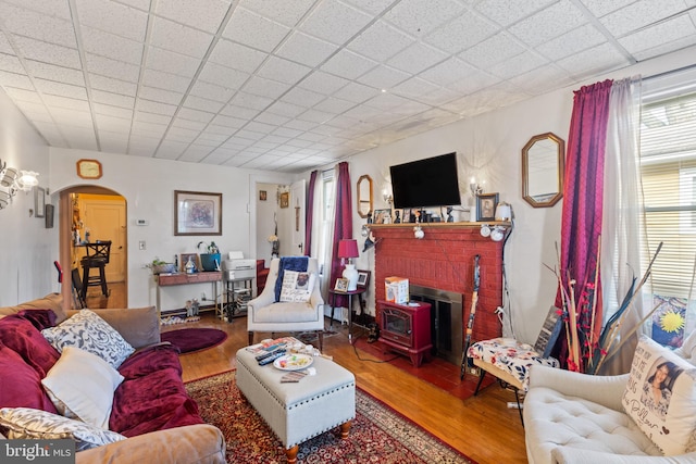 living room featuring wood-type flooring and a wood stove