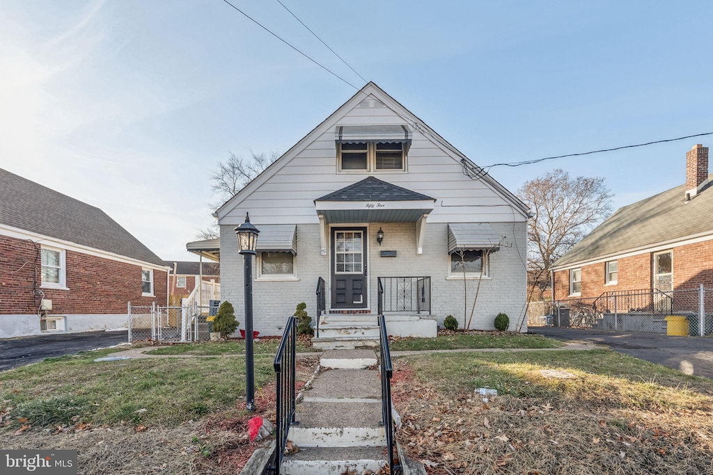 bungalow-style home featuring a front lawn