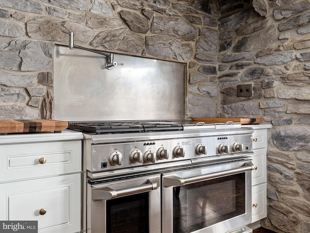 kitchen featuring white cabinets and double oven range