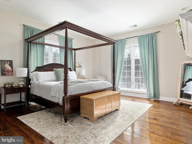 bedroom with dark hardwood / wood-style floors