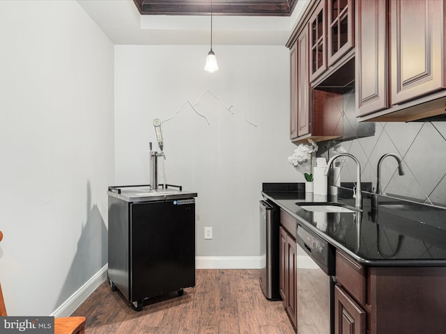 kitchen featuring stainless steel dishwasher, tasteful backsplash, sink, and dark wood-type flooring