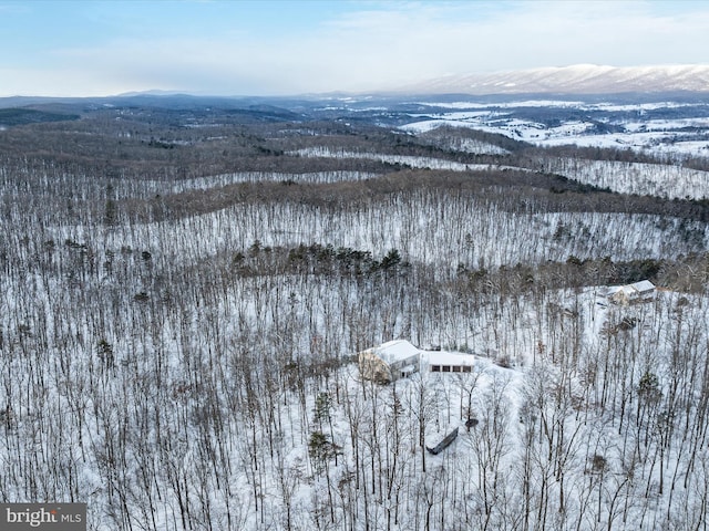 snowy aerial view featuring a mountain view