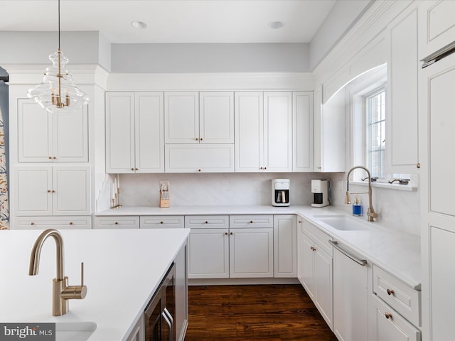 kitchen featuring decorative backsplash, white cabinetry, sink, and pendant lighting