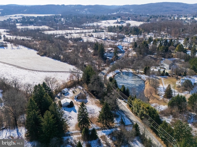 snowy aerial view with a mountain view