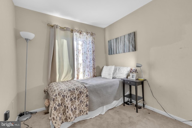 bedroom featuring light colored carpet