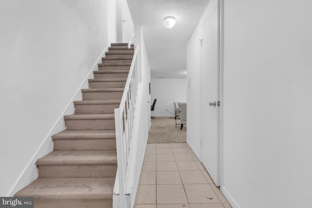 stairs featuring tile patterned floors