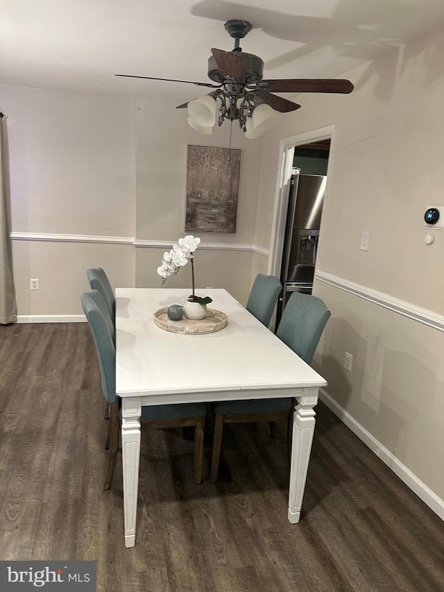 dining area with dark wood-type flooring and ceiling fan