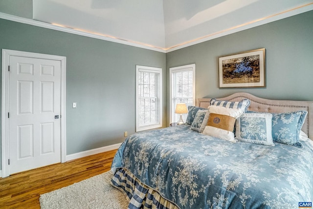 bedroom with crown molding and wood-type flooring