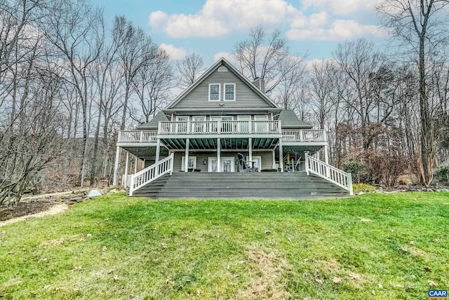 rear view of property featuring a deck and a yard