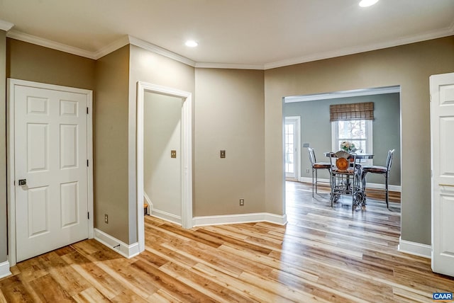 interior space with light wood-type flooring and ornamental molding