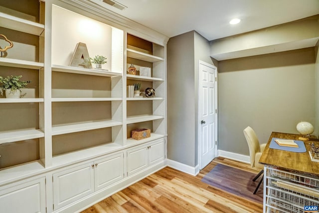 office space featuring light wood-type flooring and built in features