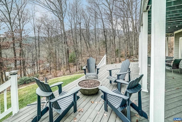 deck featuring a yard and an outdoor fire pit