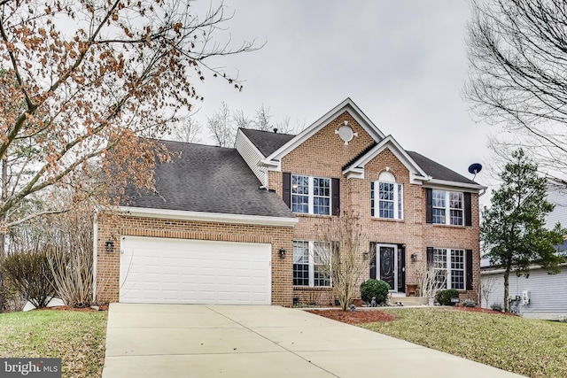 colonial home featuring a front lawn and a garage