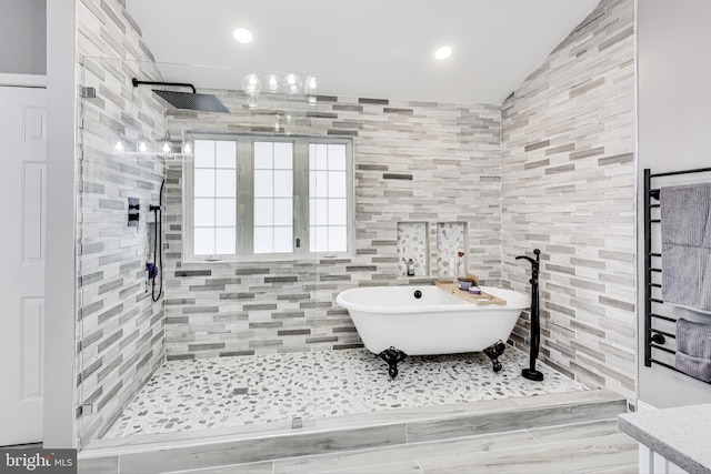 bathroom featuring plus walk in shower and vaulted ceiling