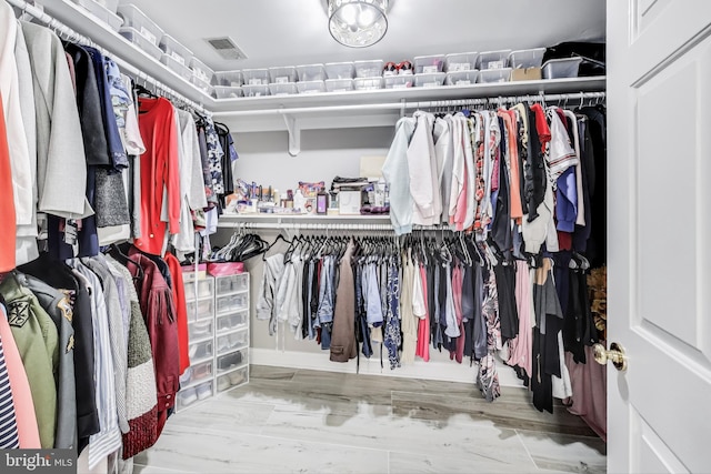 spacious closet featuring light hardwood / wood-style floors