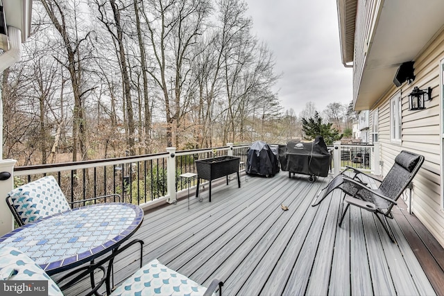 wooden deck featuring area for grilling