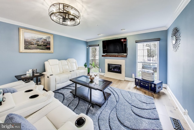 living room featuring light wood-type flooring and ornamental molding