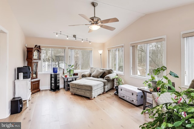 sitting room with plenty of natural light, ceiling fan, light hardwood / wood-style flooring, and vaulted ceiling