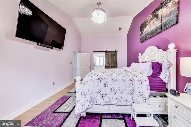 bedroom with lofted ceiling, light hardwood / wood-style flooring, and crown molding