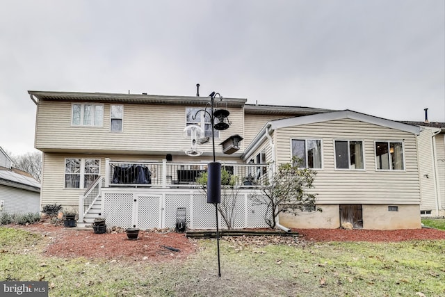 rear view of house with a yard and a deck