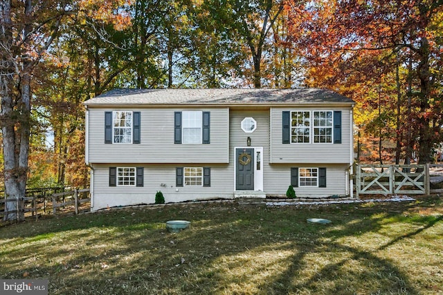 raised ranch featuring a front lawn