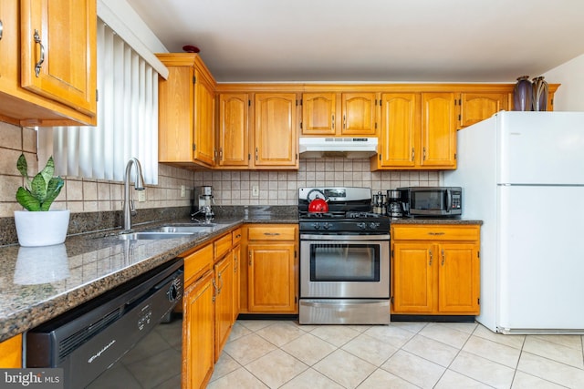 kitchen with appliances with stainless steel finishes, tasteful backsplash, light tile patterned floors, and sink