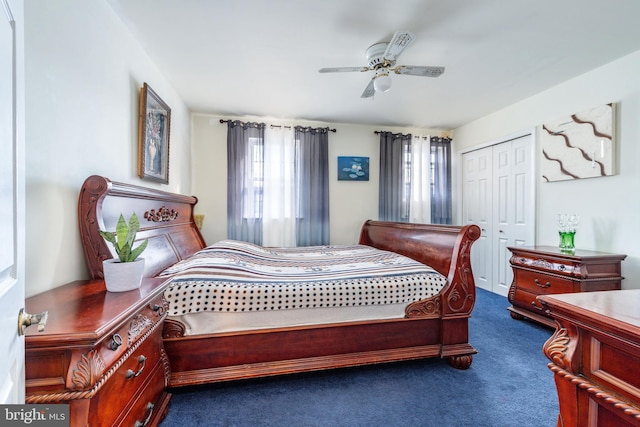 bedroom with dark carpet, a closet, and ceiling fan