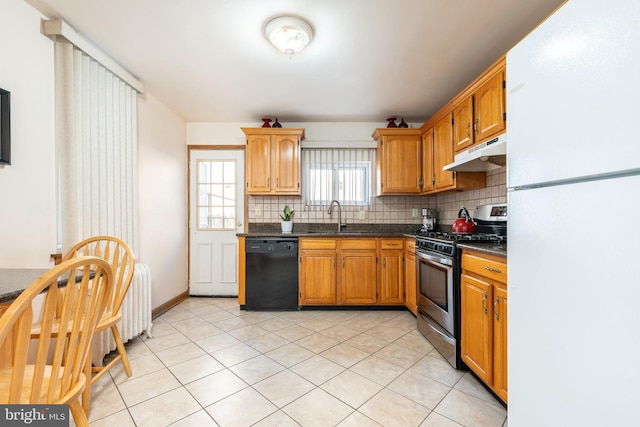 kitchen featuring dishwasher, sink, stainless steel gas range, tasteful backsplash, and white fridge