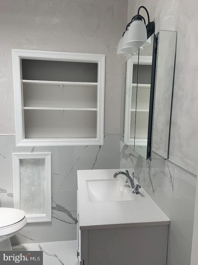 bathroom featuring vanity, tasteful backsplash, and toilet