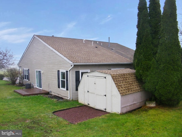 back of house featuring a storage unit and a yard