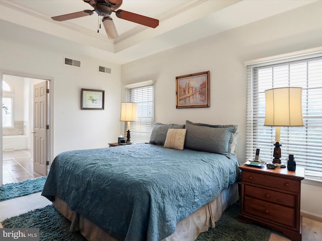 bedroom featuring ensuite bathroom, light tile patterned flooring, ceiling fan, and multiple windows