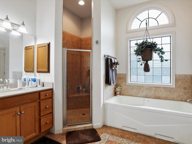 bathroom with tile patterned flooring, plus walk in shower, and vanity