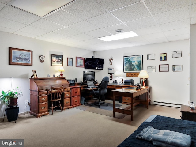 carpeted office with a paneled ceiling and baseboard heating