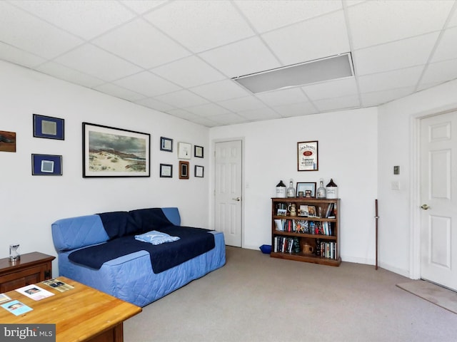 carpeted bedroom with a paneled ceiling