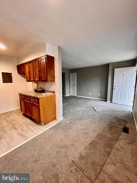 kitchen with light colored carpet