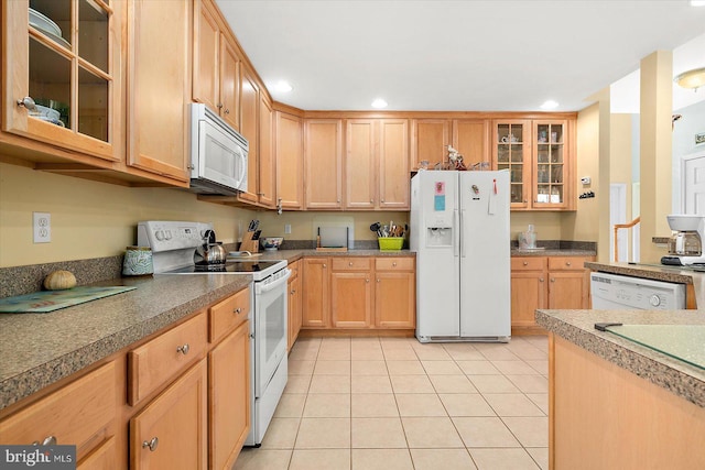 kitchen featuring white appliances and light tile patterned floors