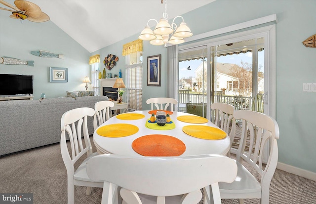 carpeted dining room featuring lofted ceiling and a notable chandelier