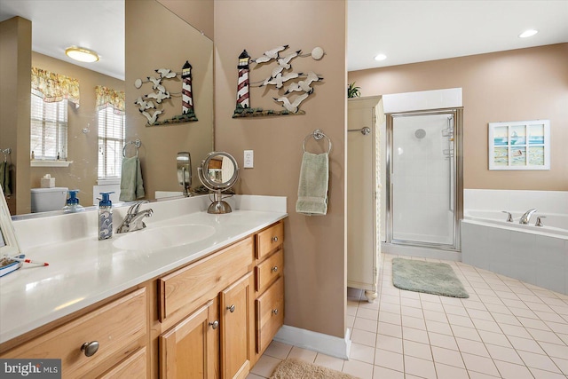 bathroom featuring tile patterned floors, vanity, and plus walk in shower