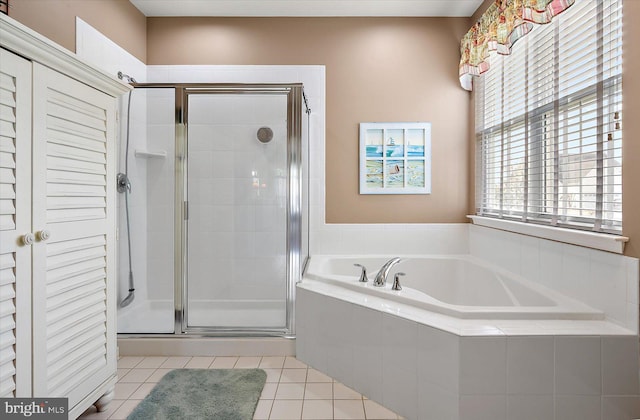 bathroom featuring tile patterned flooring and independent shower and bath