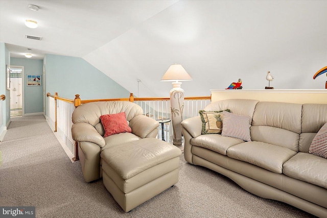 carpeted living room featuring vaulted ceiling