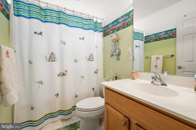 bathroom with tile patterned floors, vanity, and toilet