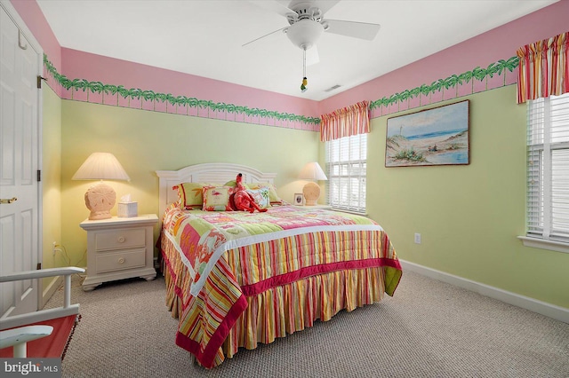 carpeted bedroom with ceiling fan and multiple windows