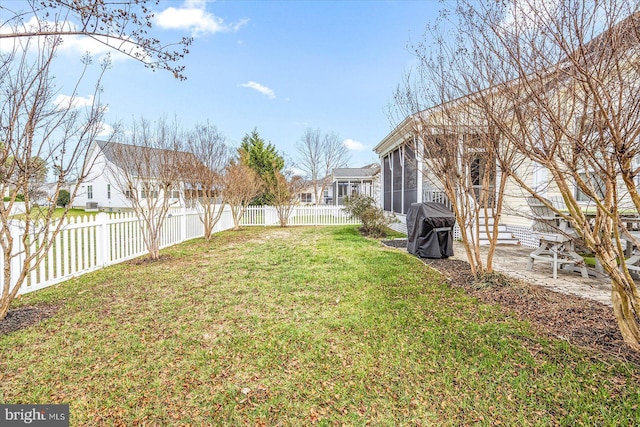 view of yard with a sunroom and a patio