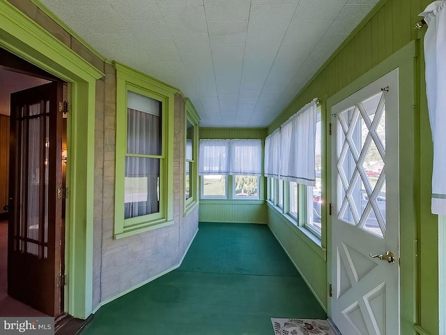 unfurnished sunroom with plenty of natural light