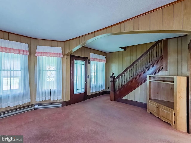 carpeted foyer entrance with wooden walls