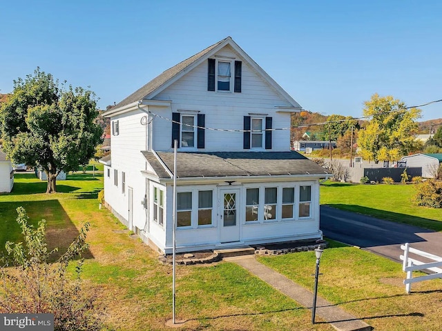 back of property featuring a yard