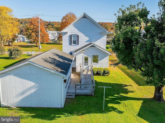 rear view of house featuring a yard