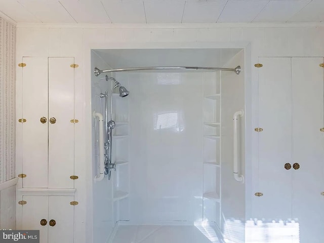 bathroom featuring a shower and crown molding