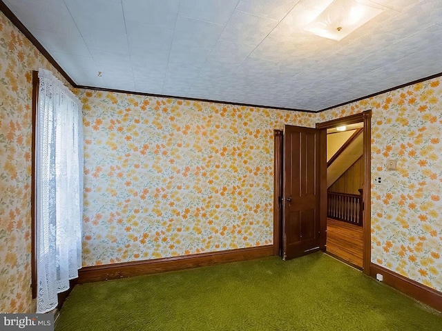 carpeted empty room with ornamental molding